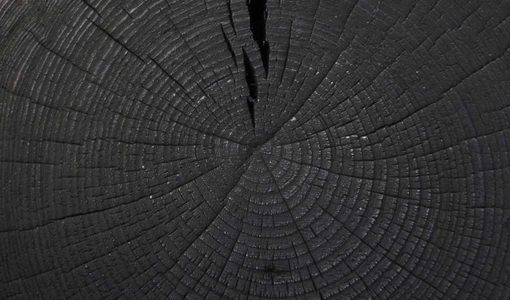 Handmade side table in burnt wood, matte black finish | Human Heritage